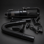 Edited studio image of the Cordless Handheld Vacuum with hose, nozzles, brushes and charging cable on a charcoal background.